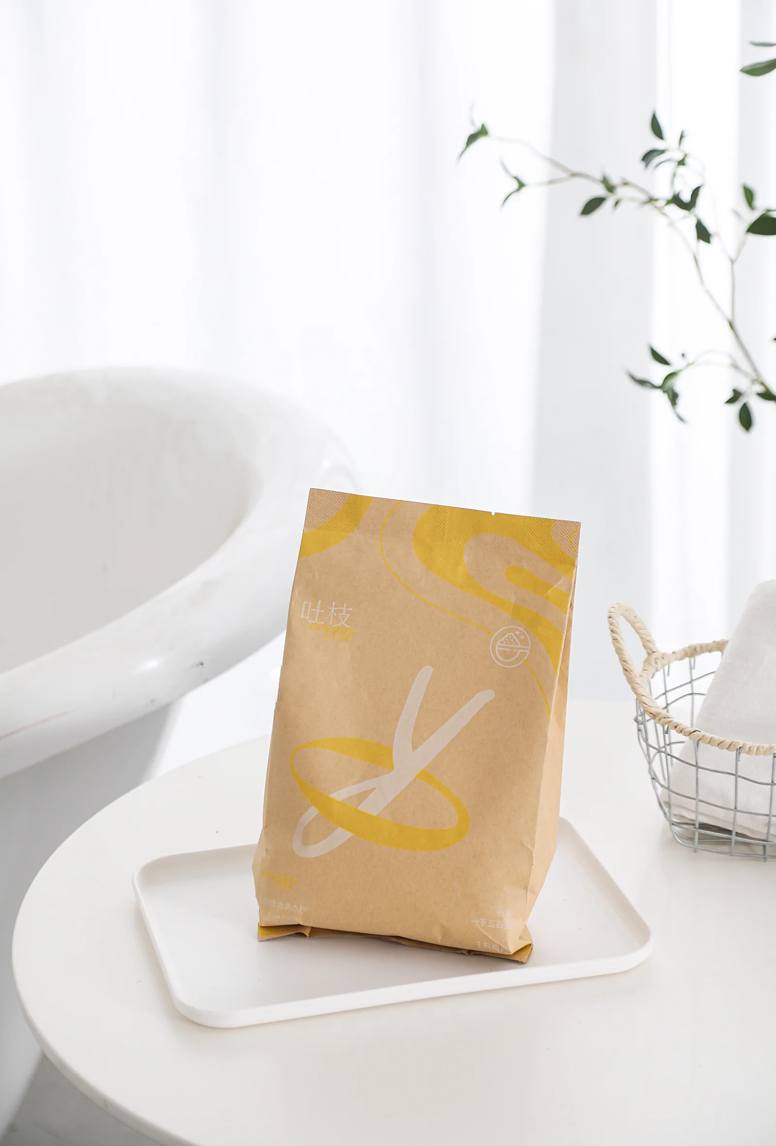 Twiggy botanical essential-oil laundry powder in a bright laundry space